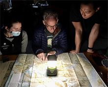 An attending teaching residents how to read a map in the wilderness