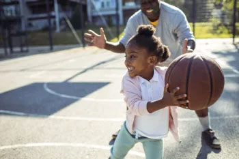 A girl plays basketball