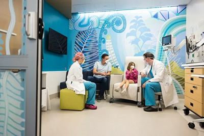 Providers meet with a patient in one of Forest B’s universal rooms.