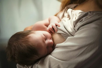 A mother nursing a baby