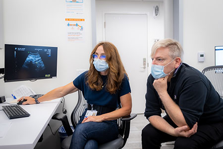 Maternal-fetal surgeons Drs. Bettina Paek and Martin Walker review a patient’s scan.