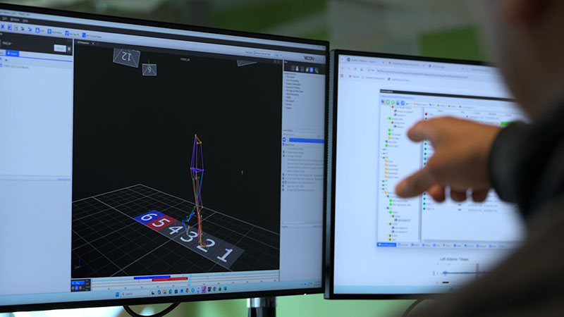 A person points at a computer monitor