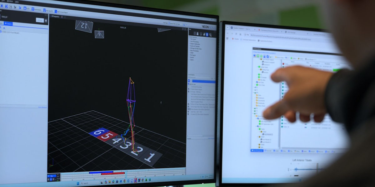 A person points at a computer monitor