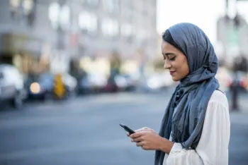 A woman texts on her phone