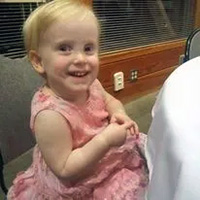A toddler in a pink dress