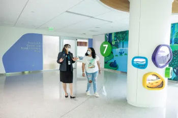 A doctor walks with a patient
