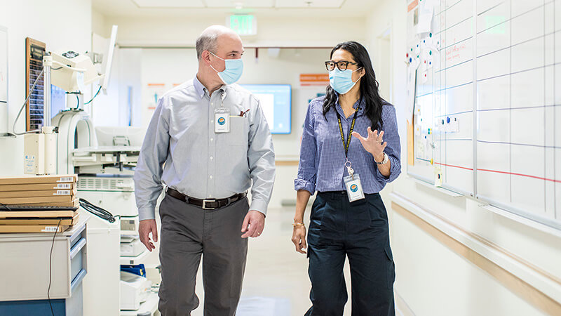 Two providers talking to each other in a hallway