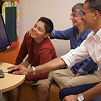 Sprout Hochberg A boy and two adults look at a computer