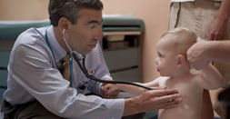 Dr. Mark Lewin listens to a young patient's heart