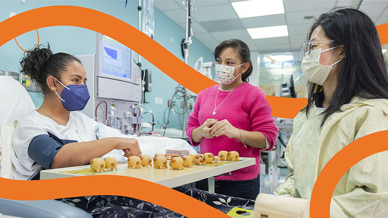 A Seattle Children's employee speaks to a patient's family