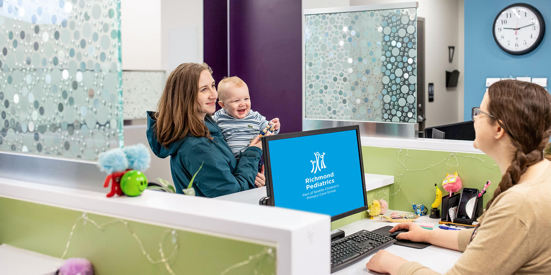 Baby with parent at reception desk