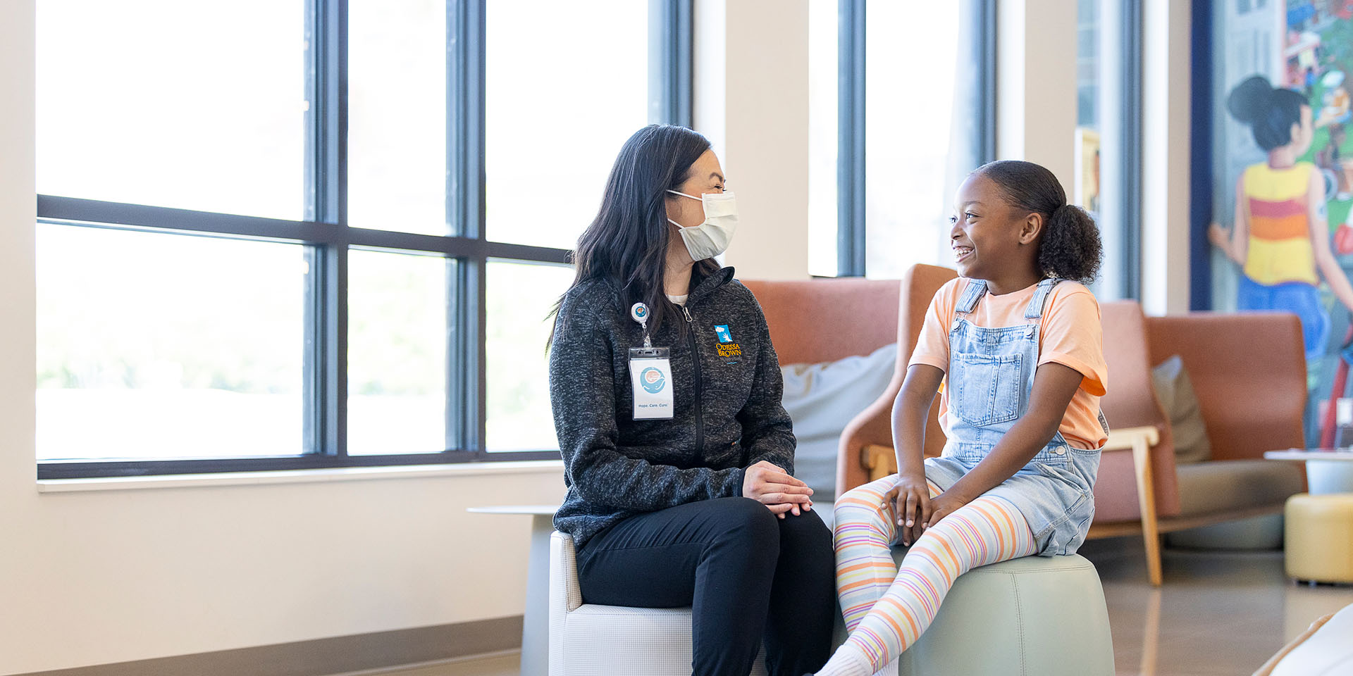 A provider talks to a patient at Seattle Children's Hospital