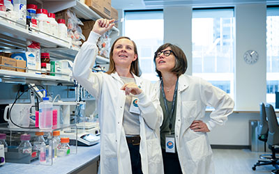 Two researchers look at a test sample