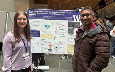 Researchers standing in front of a presentation