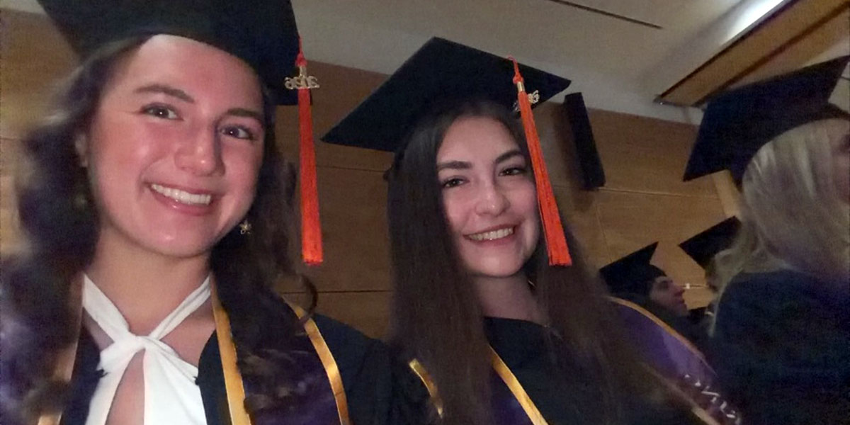 Two women in graduation gowns