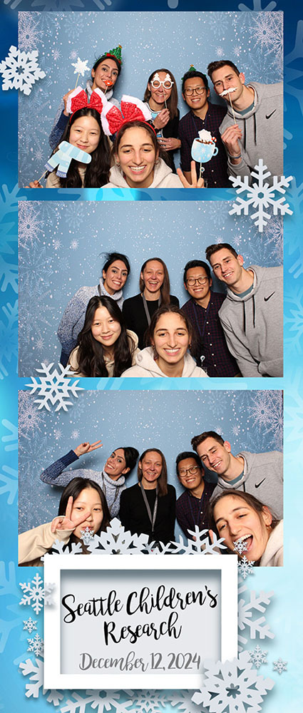 Members of the Rau Lab are photographed in the style of a holiday photo booth