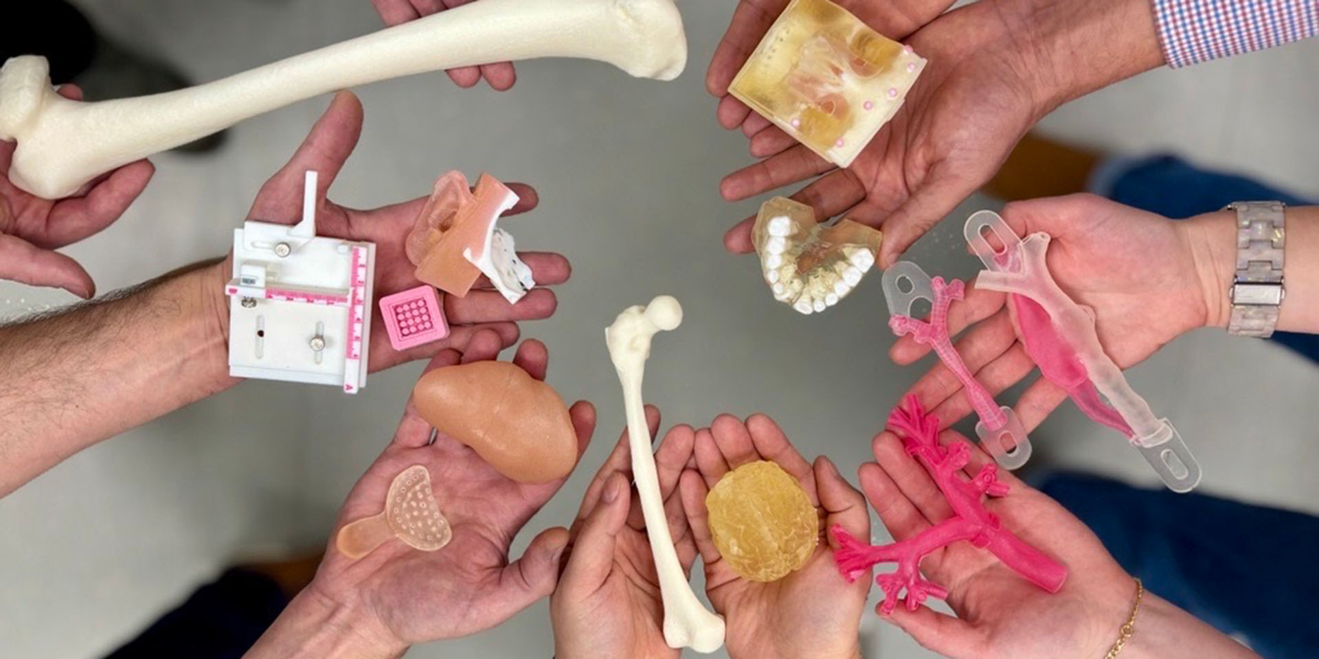 Hands hold 3D-printed models