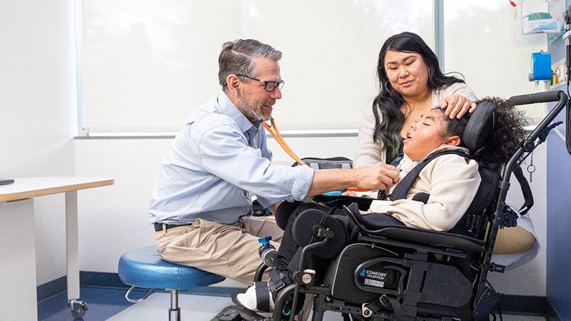 Dr. Debley seeing patient, Kevon, in clinic