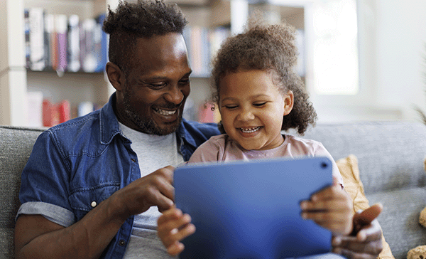 Father and daughter using a tablet