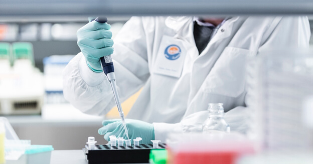A scientist holding a pipette