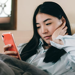 A woman looks at her phone