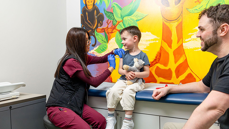 Smiling patient receives vaccine in clinic.