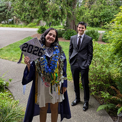 A young woman holds a graduation cap