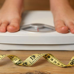 Feet on scale with measuring tape