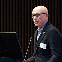 Dr. Vittorio Gallo speaking at a podium