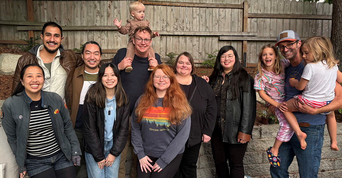 Members of the Grill Lab Pose in front of a fence