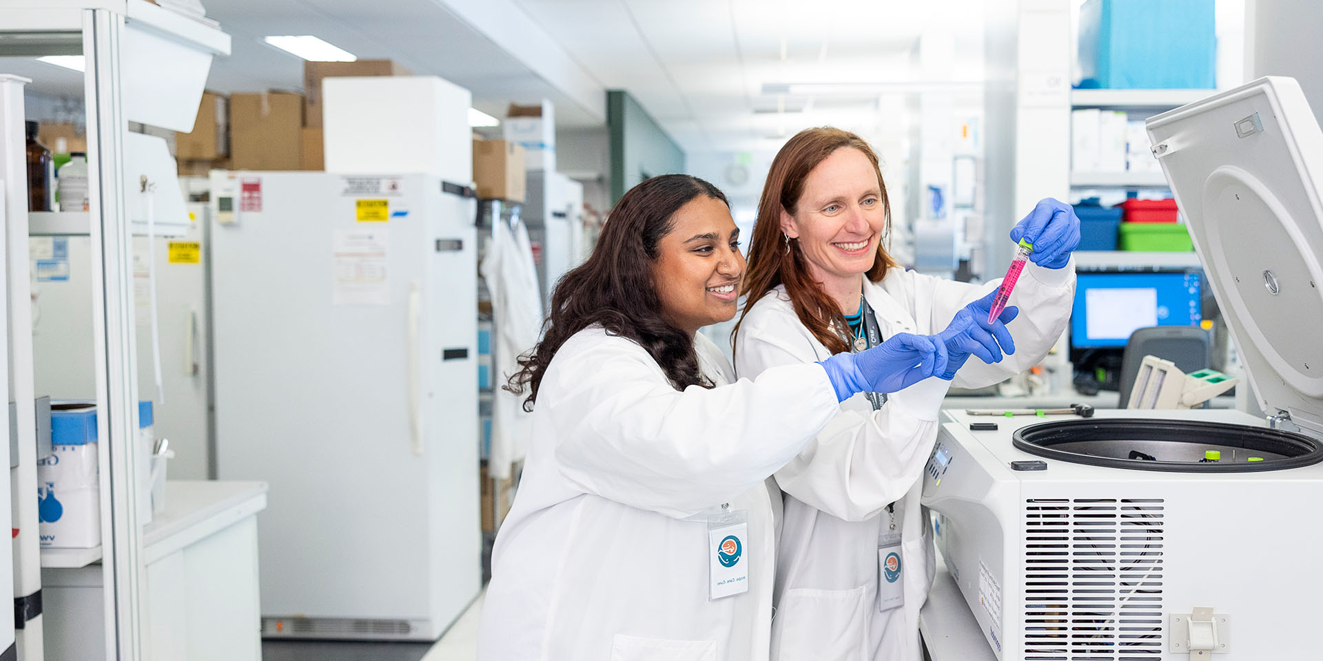 Two researchers inspect a sample
