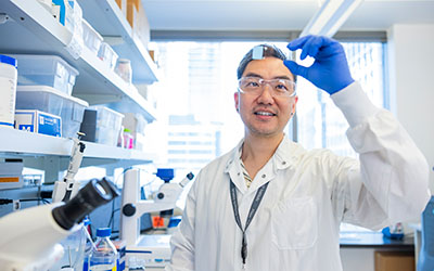 A research inspects a test slide