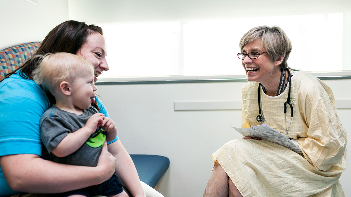 A mother and child chat with a Seattle Children's researcher