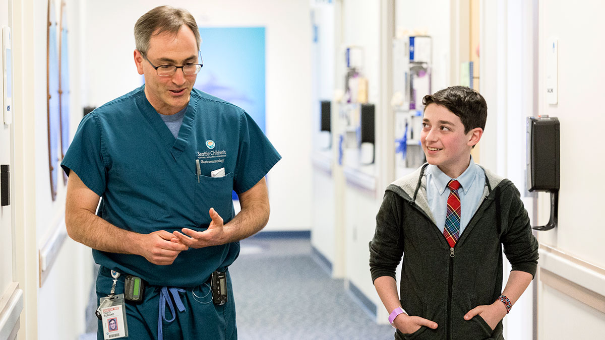 A Seattle Children's patient talks with a provider in a hallway