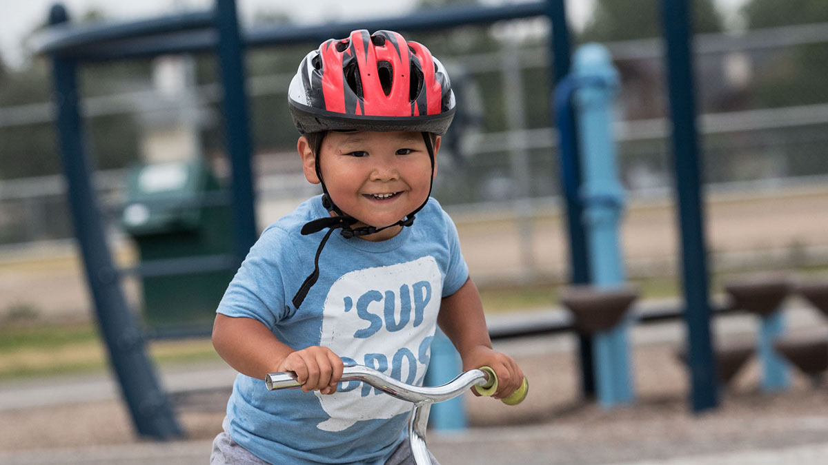 A boy in a bike helmet
