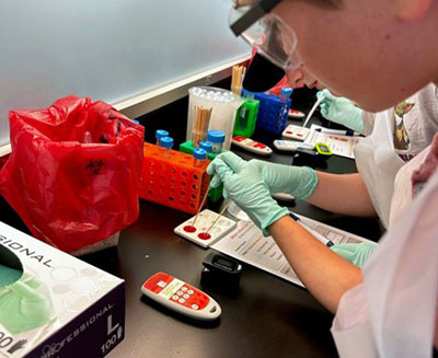 Students piping blood into a dish
