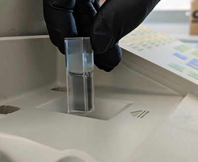 A handing holding a container containing liquid