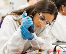 Student using a micropipette and loading an agarose gel