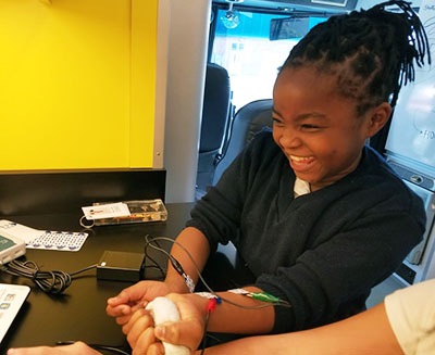 A student laughing during an experiment
