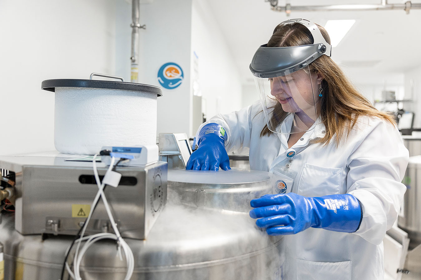 A researcher handles frozen materials