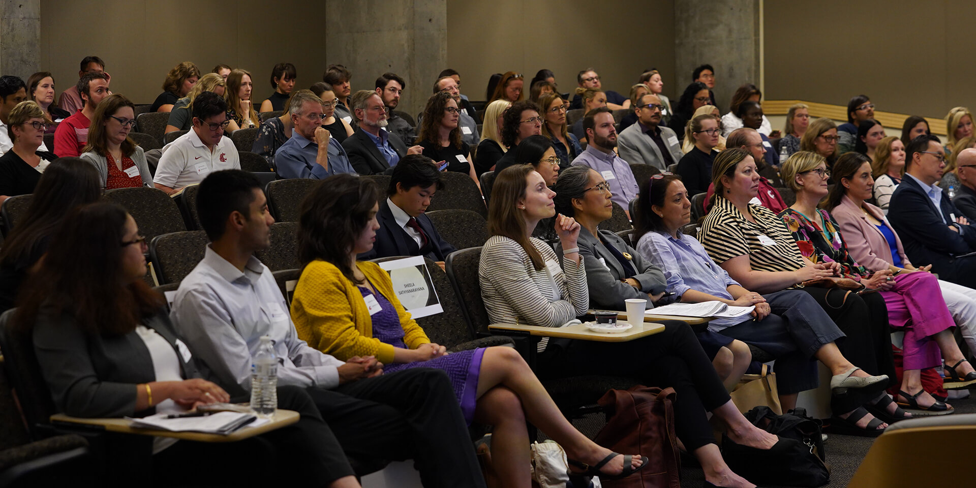 A large group of researchers sit in an auditorium at the first-ever Joint Research Symposium between Seattle Children’s Research Institute and Washington State University (WSU) Health Sciences at the WSU Spokane Campus